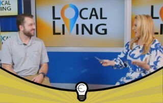 TV interview on Local Living set; two people seated with the Local Living logo on a studio screen behind them.
